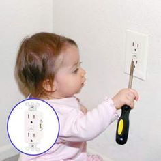 baby with a screwdriver trying to insert into a electrical outlet